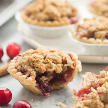 Cider Spiced Cranberry Apple Pie is so perfect for fall -- I make them in pre-made tart shells for an easy holiday dessert that will impress your guests!