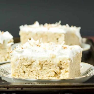 Coconut Cream Poke Cake: Homemade vanilla cake filled with homemade coconut cream pudding, topped with whipped cream and toasted coconut -- the cake for coconut lovers! Make it from scratch or use cake mix or pudding mix to make it quick and easy! www.thereciperebel.com