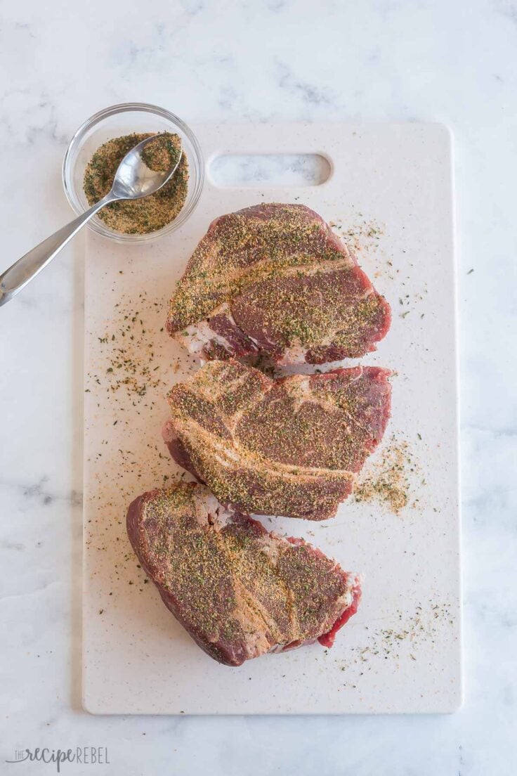 seasoning ground beef roast on cutting board