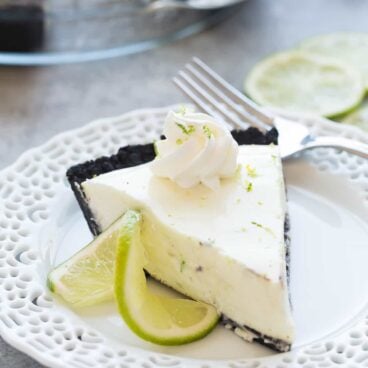 This (Almost) No Bake Key Lime Pie is made extra special with a chocolate cookie crust! It's a smooth, creamy, no fuss dessert perfect for summer or winter. Includes step by step recipe video. | no bake pie | no bake dessert | citrus | easy recipe | easy dessert