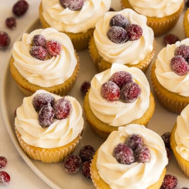 white chocolate cranberry cupcakes with sugared cranberries